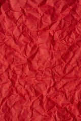 Fototapeta premium Close-up macro of wrinkled red paper texture,Red crumpled paper texture macro,Red crumpled paper as a texture or background. Bright red crumpled paper for backgrounds, design, packaging, 