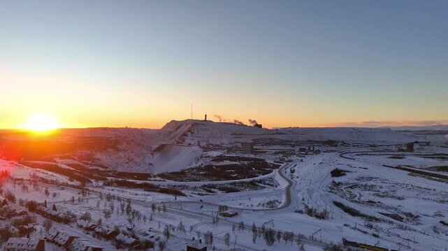 Kiruna, Sweden, aerial view over the city and the iron ore mine, during high noon just before the polar night sets in. Winter, snow, ice, clear sky