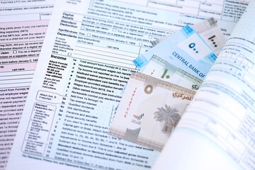 United Arab Emirates dirham money bills on tax form close up. Taxation and accounting concept