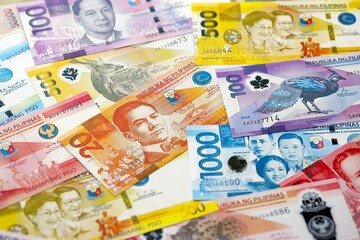 Philippines peso currency money bills. The current banknotes lies on table in big amount close up