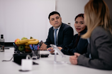 Professionals participating in a collaborative business meeting in a formal office environment