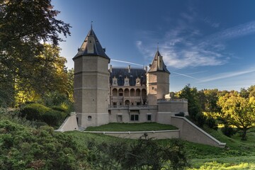 Fototapeta premium view of the historic magnate Renaissance Goluchow Castle surrounded by forest under a blue sky