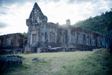 Ancient stone church in the mountains with temple-style architecture and historic ruins under an open sky