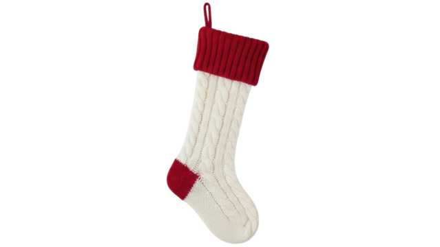 Isolated festive cable knit Christmas stocking with red cuff and toe for holiday season