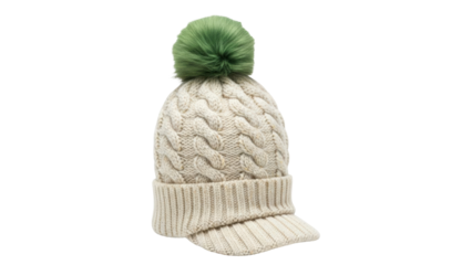 Isolated knit cable cap with peak and green pom pom for winter or spring fashion style