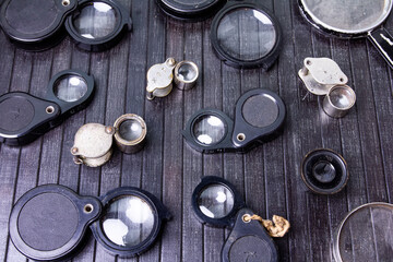 many different magnifying glasses on a black background