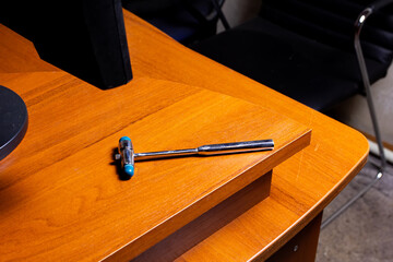 the reflex hammer is on the edge of the table