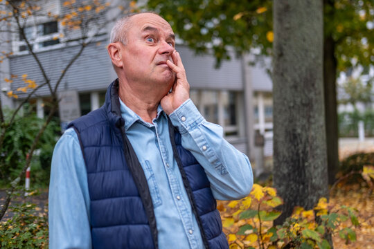 mature bald man man lost in deep thoughts outdoors, mental health senior sad expression while gazing away, melancholy and reflection, retirement lifestyle, simple portrait, rest and contentment