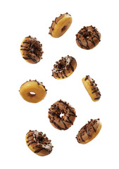 A variety of donuts are scattered across a white background, featuring chocolate icing and sprinkled toppings. They look fresh and inviting, perfect for a sweet treat at any time.