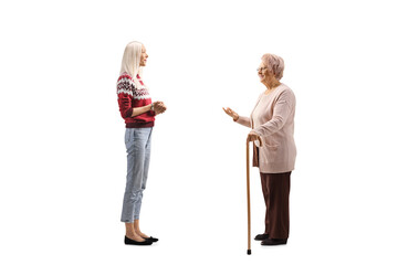Elderly woman talking to young woman in a red sweater