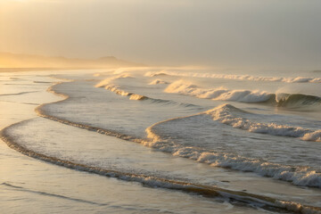 Golden Sunrise Waves on Misty Beach