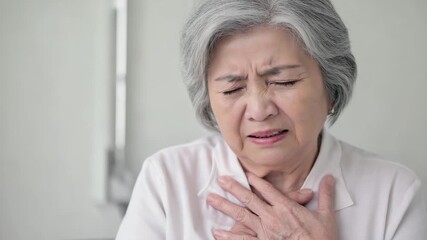 old asian woman touching her chest and feeling pain in heart. Healthcare and medicine