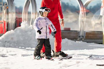 Ski coach giving a lesson to a child