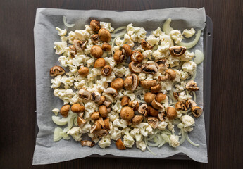 Raw Cauliflower, Mushrooms, and Onion on Tray – Seasoned and Ready to Roast