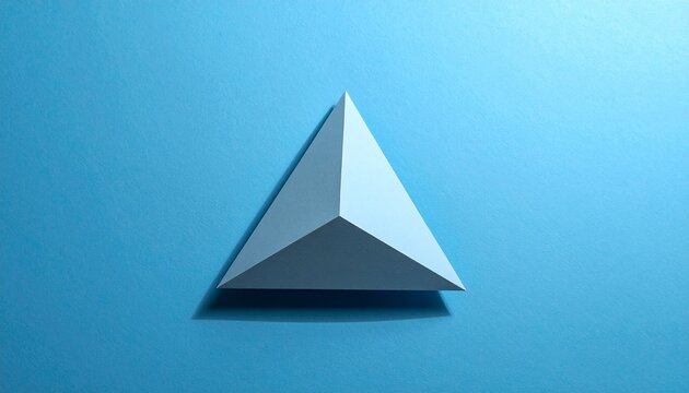 White Triangular Pyramid on Textured Blue Background in Minimalist Geometric Close-Up Composition