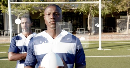 Holding center wearing navy white striped jersey gripping white oval ball on turf near goalpost HUD