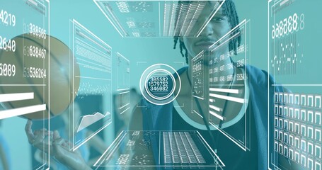 Standing dreadlocked man in tank hoodie using AR panels and circular target at tech lab, basketball