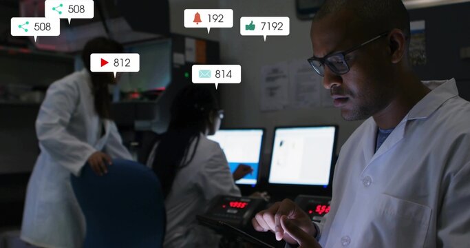 Monitoring lab-coated man using tablet in dim control room, monitors and social icons, copy space