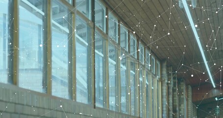 Showing row of tall glass windows with wooden frames in interior corridor, with network overlay
