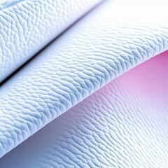 Close-up of folded white leather with textured surface and soft lighting, creating a minimalist and abstract design.