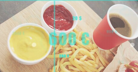 Displaying fries on wooden board at counter with sauces red cup wrapped sandwich turquoise overlay