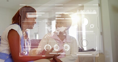 Showing nurse in white stethoscope using tablet at home, senior in cardigan pink blouse viewing HUD