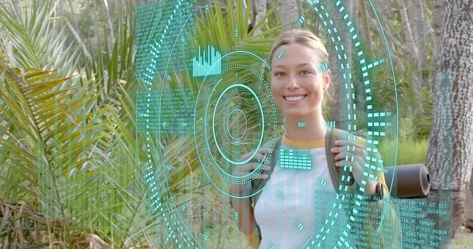 Smiling hiker wearing short sleeve top with backpack in woods rolled mat cyan HUD, copy space