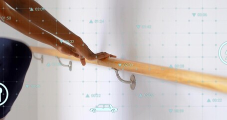 Gripping mid adult woman in fitted exercise wear holding wooden barre at studio, with overlays © vectorfusionart