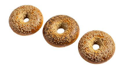 Three assorted bagels with seeds isolated on a transparent background food baked
