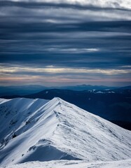 Majestic Snow-Capped Mountain Peaks Under Dramatic Cloudy Sky