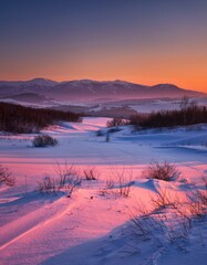 Serene Winter Landscape at Sunset with Snow-Covered Mountains