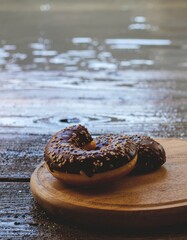 Chocolate Glazed Donuts with Sprinkles on Wooden Surface