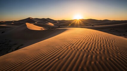 Majestic Desert Sunset with Golden Sunburst and Intricate Rippled Sand Dunes.