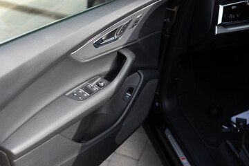 Control buttons for settings and memory of the driver's seat, electric glass opening, door handle in the interior of the new luxury electric, diesel or hybrid car. Driver's seat adjustment buttons