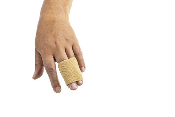 Close-up of a human hand with a beige elastic bandage wrapped around the middle and ring fingers, isolated on a white background.