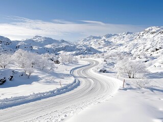 A scenic winter landscape featuring a winding road through snow-covered mountains, trees, and a clear blue sky. The image captures a sense of tranquility and th