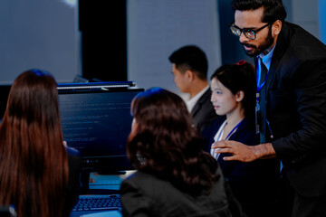 A strategy team reviews predictive analytics generated by an AI platform. The lead points to a forecast, guiding the team in making a critical, data-driven business decision.