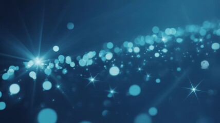 Abstract blue bokeh background with sparkling stars and radiant glow.
