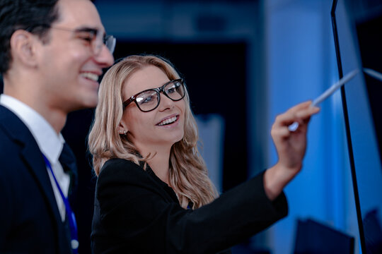 Validating the future AI. A specialist points out a crucial parameter in an AI model's code displayed on screen discussing its ethical implications with her colleague before deployment. - Powered by Adobe