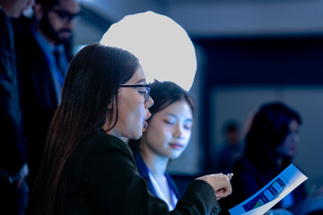 Briefing future AI insights. Lead analyst points out predictive patterns AI generated report chart team discusses strategic implications real time data streams flow screens background.