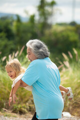 Fototapeta premium senior woman with caucasian young girl, social responsibility, accountability with trash, garbage or dirt. volunteer charity people. charity community service event, ngo business and outreach