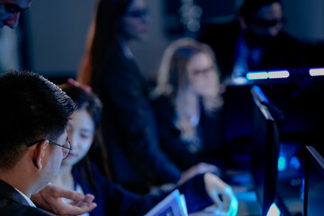 Peak focus mode activated. Diverse professionals collaborate intense concentration late night modern tech hub synergy pushing project forward multiple screens data flowing team winning.