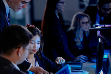 Cyber defenders hold the line late night ops center. Focused diverse analysts track threats multiple screens real time data intelligence crucial vigilance protects vital systems now.
