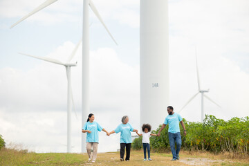 Volunteers are walking behind a windmill farm, volunteer charity people. charity community service event, ngo business and outreach, Group Diverse people meeting at park for donation