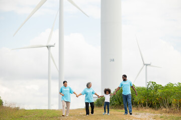 Volunteers are walking behind a windmill farm, volunteer charity people. charity community service event, ngo business and outreach, Group Diverse people meeting at park for donation