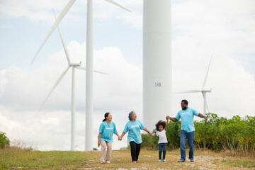 Volunteers are walking behind a windmill farm, volunteer charity people. charity community service event, ngo business and outreach, Group Diverse people meeting at park for donation