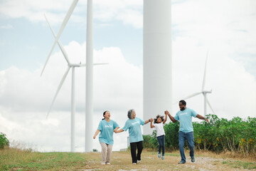 Volunteers are walking behind a windmill farm, volunteer charity people. charity community service event, ngo business and outreach, Group Diverse people meeting at park for donation