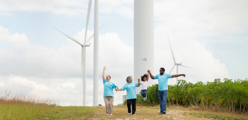 Volunteers are walking behind a windmill farm, volunteer charity people. charity community service event, ngo business and outreach, Group Diverse people meeting at park for donation