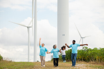 Volunteers are walking behind a windmill farm, volunteer charity people. charity community service event, ngo business and outreach, Group Diverse people meeting at park for donation