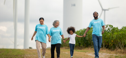 Volunteers are walking behind a windmill farm, volunteer charity people. charity community service event, ngo business and outreach, Group Diverse people meeting at park for donation